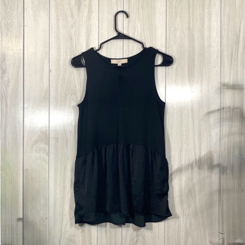 Loose fitting LOFT tank with satin-like accent at bottom.